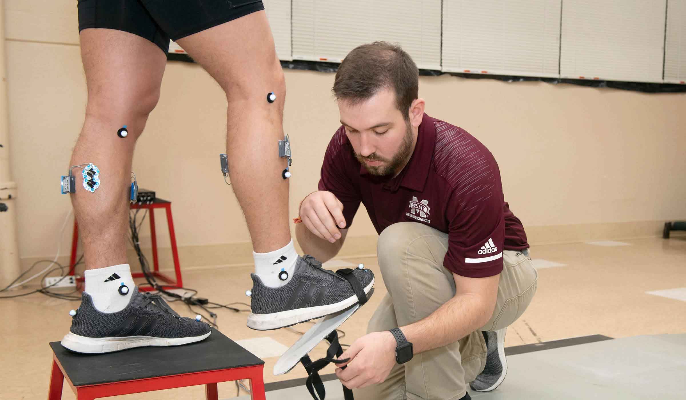 student running neuromechanical tests on patient